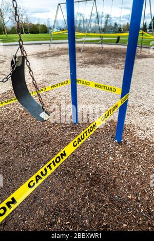 Surrey, Canada - Mar 29, 2020: Swings and playground closed due to Coronavirus Covid-19 pandemic Stock Photo