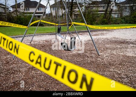 Surrey, Canada - Mar 29, 2020: Swings and playground closed due to Coronavirus Covid-19 pandemic Stock Photo