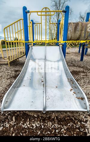 Surrey, Canada - Mar 29, 2020: Children's public playground slide closed due to Covid-19 epidemic Stock Photo