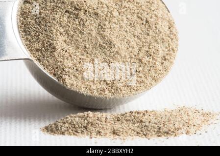 Ground White Pepper Spilled from a Teaspoon Stock Photo