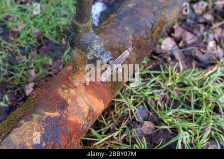 rusty water pipe with leaking tap Stock Photo