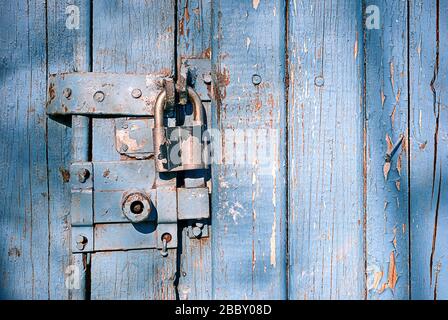 locked latch and padlock on old door Stock Photo