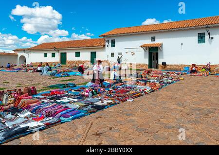 Local Quechua indigenous textile saleswoman in traditional clothing on the art and craft market of Chinchero, Cusco Province, Peru. Stock Photo