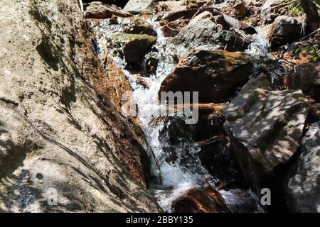 A small waterfall over a rocky cliff Stock Photo