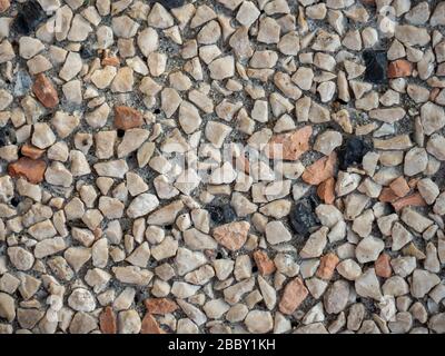 Granite crumb material textured surface abstract background. Rough hard pebble, marbeled wall, flooring. Stock Photo