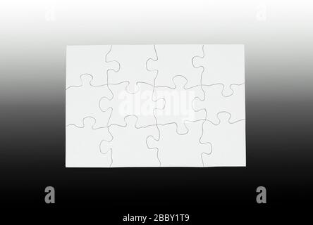Blank white puzzle put together with large pieces isolated on graduated black and gray background Stock Photo