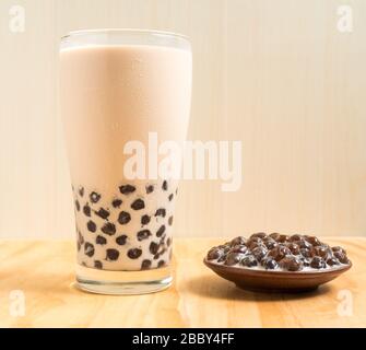 A glass cup of pearl milk tea (also called bubble tea) and a plate of  tapioca ball on white background. Pearl milk tea is the most representative  drin Stock Photo - Alamy