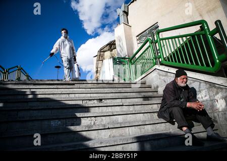 Beijing, Iran. 31st Mar, 2020. A volunteer disinfects a street in Tehran, Iran, on March 31, 2020. Credit: Ahmad Halabisaz/Xinhua/Alamy Live News Stock Photo