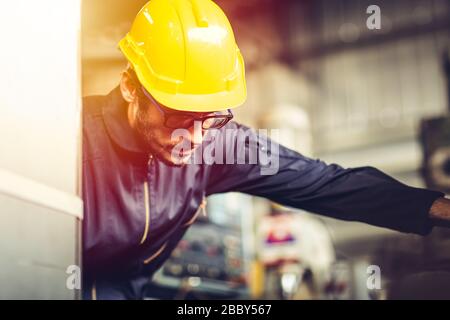Young American worker intend to work in a heavy industrial factory. Stock Photo