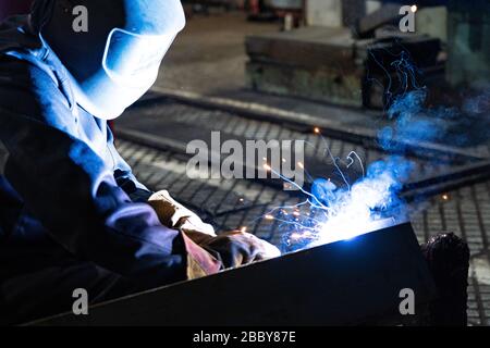 The work of the welder. Welding work in the factory floor Stock Photo