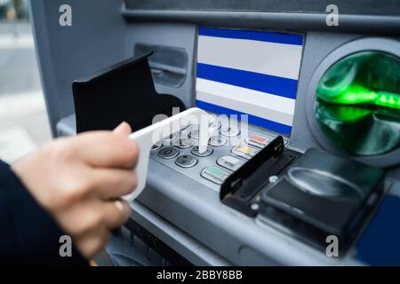 Wearing Using ATM With Contactless Tool To Protect From Coronavirus Infection Stock Photo