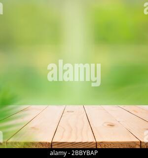 Empty wood table top on blur abstract green garden from window view.For montage product display or design key visual layout Stock Photo