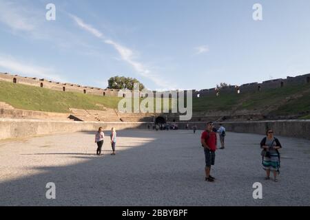 Tourist inside the Amphitheater of Pompeii, Italy Stock Photo