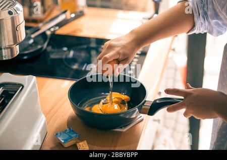 Cooking breakfast on kitchen counter bar in morning.Healthy food,simple eating lifestyle. Stock Photo