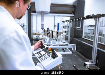 Quality engineer measuring plastic component on professional 3D measurement in automotive factory, industrial concept Stock Photo