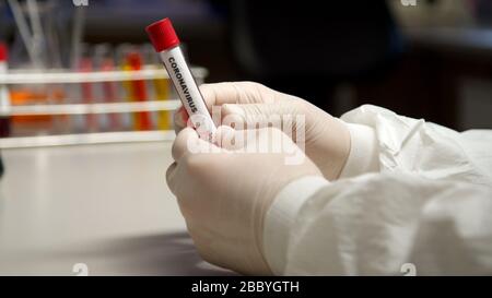 Scientist marking with pen Coronavirus test tube Stock Photo
