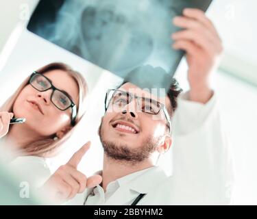 two orthopedic doctors looking at the x-ray of the patient Stock Photo