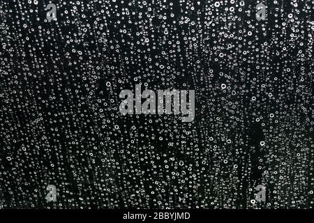 Water drops on black. Background of drops of water rain on glass transparent Stock Photo