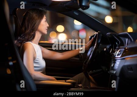 Confident Chinese businesswoman driving car Stock Photo