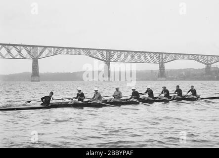 Cornell University crew team on the Hudson River, Poughkeepsie Railroad Bridge in the background ca. 1912 Stock Photo