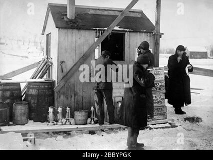 Dietz lantern boxes and lanterns next to soup-house for men cutting ice ca. 1910-1915 Stock Photo