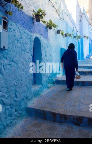 Chefchaouen, Morocco: veiled woman walking in the Medina Stock Photo