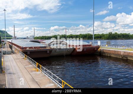 A barge entering a lock and dam on the Mississippi River. Stock Photo