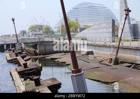 KOBE, JAPAN - APRIL 24, 2012: People visit the ruined Meriken Wharf in Kobe. It was damaged by the Great Hanshin Earthquake in 1995 and is preserved a Stock Photo