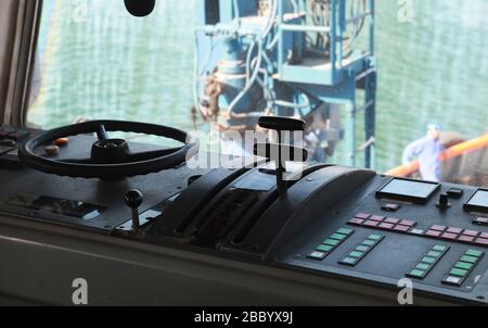 Control panel with steering wheel of a tug boat. Photo of a captains bridge Stock Photo