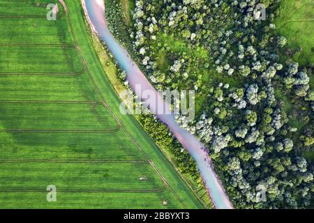 Flight through majestic Ukrainian landscape with river Dnister and green fields at sunset time. Summertime Stock Photo