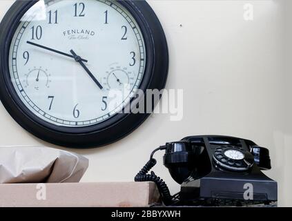 Fenland Fine clock and a traditional dial telephone from the 1960s The Brookfields Post Office, recreating a provincil post office counter of the 1960 Stock Photo