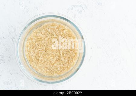 Soaking brown rice cereal in water to ferment cereals and neutralize phytic acid. Stock Photo