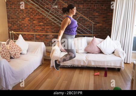 Plus size female vlogger self isolating exercising at home Stock Photo