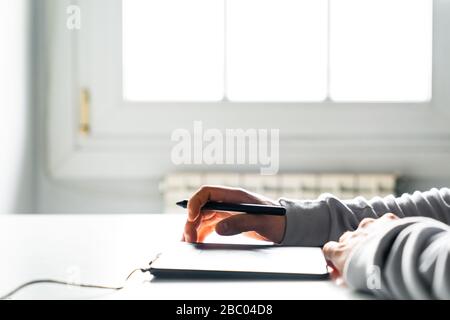 Young man designer using a stylus and graphics table Stock Photo