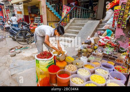 Colourful spices and dried vegetables on display: street scene in Mahipalpur district, a suburb near Delhi Airport in New Delhi, capital city of India Stock Photo