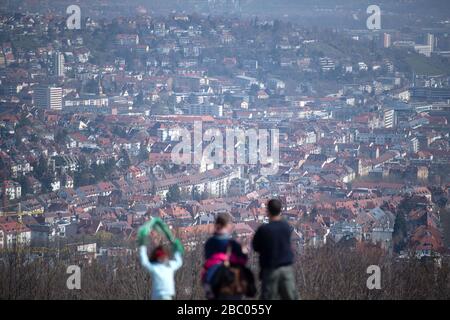 Stuttgart, Germany. 02nd Apr, 2020. People stand on the Birkenkopf and look at the view of the city centre. More than 15,000,000 cubic metres of rubble were deposited on the hill after the Second World War. The mountain is popularly known as 'Monte Scherbelino'. Credit: Marijan Murat/dpa/Alamy Live News Stock Photo