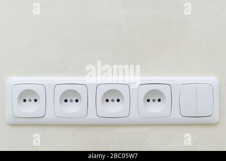 White socket outlets on beige wall. with copy space Stock Photo