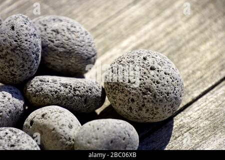 close-up of gray porous lava pebbles background, round lave stones as garden decoration Stock Photo