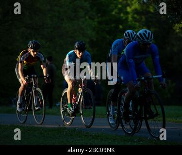 Cyclists caught in the sunlight whilst competing in Criterium Race at Crystal Palace Park. Stock Photo