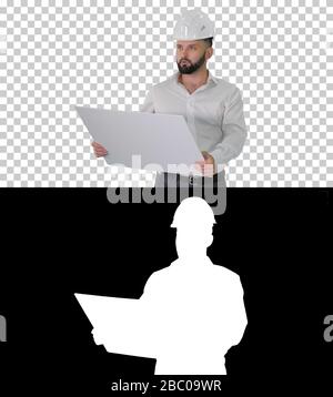Man engineer walking in helmet looking at project of reconstruct Stock Photo