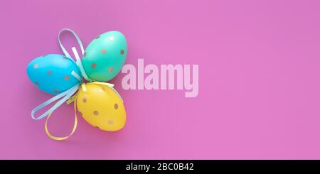 Easter eggs on pink background, paschal gift card with text space. Art design decoration. Colorful paschal egg, holiday pattern, mockup. Wide panorama Stock Photo