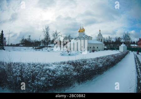 Pyatnitsky Compound of the Holy Trinity St. Sergius Lavra, Vvedensky church, freezing snowy day, blue sky, golden domes, winter lanscape Stock Photo