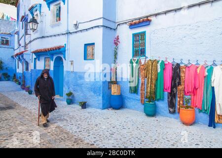 Chefchaouen, Morocco: man ina traditional  jillaba walks in the Medina. Stock Photo