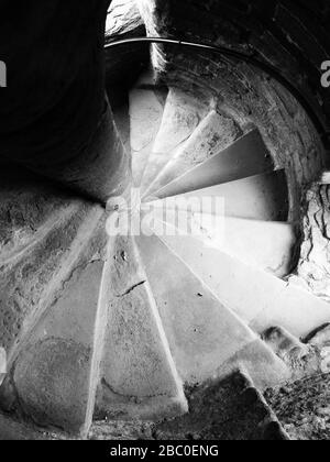 Steep spiral stone staircase in Ludlow Castle in the town of the same name in the Shropshire Hills Area of Outstanding Natural Beauty, UK Stock Photo