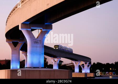 Night time shot of the monorail returning from the Palm Atlantis Resort, a luxury hotel resort at Palm Jumeirah, Dubai, United Arab Emirates. Stock Photo