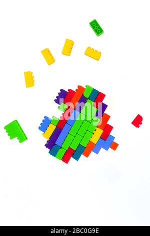 Beautiful heart shape made with lot of different colored building blocks in front of an isolated white background Stock Photo