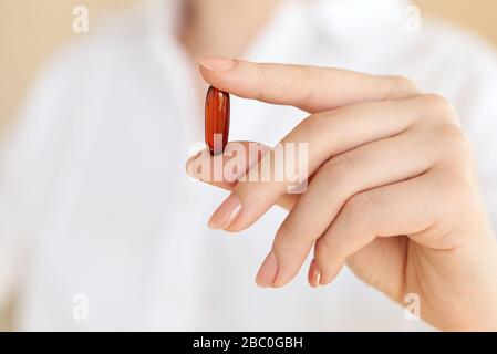 Young Women holding Medicine capsule in a hand on white background.Concept for Healthcare. Covid 19. Coronavirus Stock Photo
