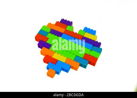 Heart shape made with lot of different colored building blocks in front of an isolated white background Stock Photo