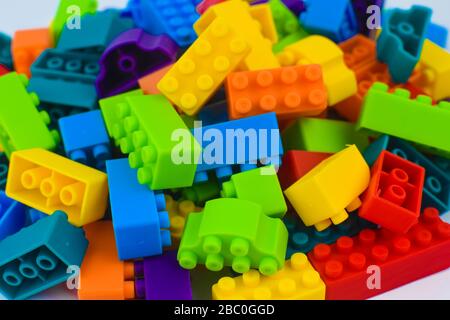 Lot of different color building blocks gathered together before an isolated white background Stock Photo