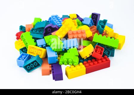 Portrait of different color building blocks gathered together before an isolated white background Stock Photo